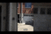 a brick building with a white garage door and a sign that says " adjust yourself and step back "