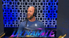 a man wearing headphones and a shirt with the letter b on it