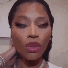 a close up of a woman 's face with pink lipstick and a white shirt .