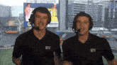 two men wearing headphones and shirts that say btv on them