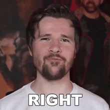 a man with a beard is wearing a white shirt with the word right written on it .
