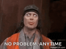 a man wearing a helmet and an orange vest is making a funny face and saying `` no problem anytime '' .