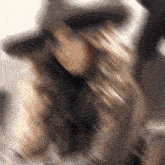 a blurry picture of a woman with long hair wearing a hat