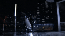 a person in a black suit is standing on a tile floor