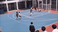 a group of people are playing a game of soccer on a blue field