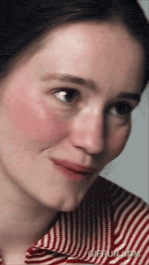 a close up of a woman 's face with a gifrun.com watermark