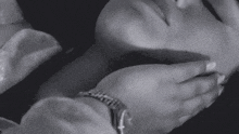 a black and white photo of a woman wearing a rolex watch