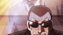 a man wearing sunglasses and a suit has the letter a on his head