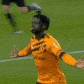 a soccer player with the number 4 on his back is hugging another player on the field