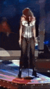 a woman in a corset is singing into a microphone