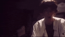 a man in a lab coat is making a surprised face