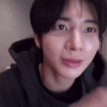 a close up of a person 's face with a hoodie on and a pink lip .
