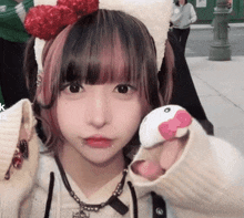 a girl wearing a headband with a hello kitty on it