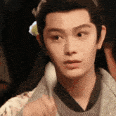 a close up of a young man 's face with a very serious look on his face