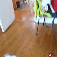 a gif of a person walking on a wooden floor with the words gif me at the bottom