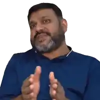 a man with a beard wearing a blue shirt is clapping
