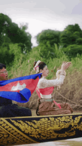 a man and a woman in a boat with a flag