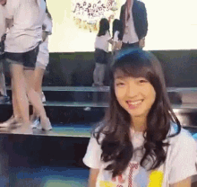 a girl wearing a t-shirt that says ' a ' on it