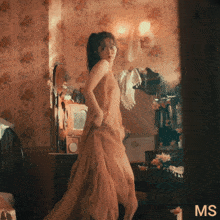 a woman in a long dress is dancing in a room with the word ms on the bottom