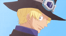 a man with blonde hair wearing a black hat with goggles