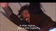 a man laying on the ground with the words " a little higher just a little higher " above him