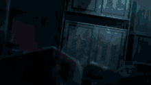 a man in a white shirt is standing in a dark room with his arm outstretched