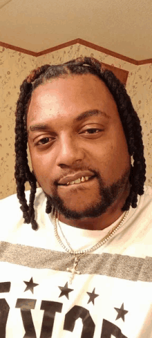a man with dreadlocks and a beard wears a shirt that says houston