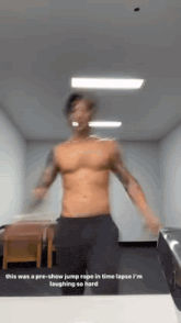 a shirtless man is jumping a rope in a room .