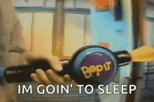 a person is holding a bop it toy and saying im goin ' to sleep