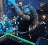 a woman wearing glasses and a black crop top with the letter r on it