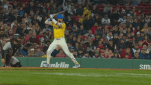 a baseball player is swinging at a ball in front of a smartwater advertisement