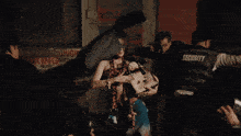 a man in a security vest holds a woman 's leg