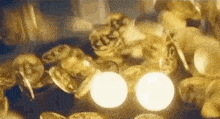 a bunch of gold coins are falling on a table