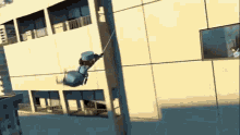 a cartoon character is flying through the air while hanging from a pole .