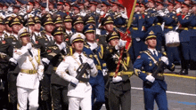 a group of soldiers marching in a line with a drummer