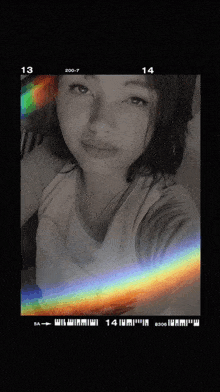 a black and white photo of a girl with the numbers 13 14 and 200-7