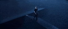 a person wearing a black shirt with the number 10 on it is running in the water