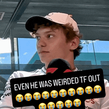 a young man holding a sign that says even he was weirdered tf out