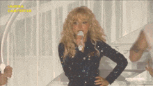 a woman singing into a microphone with the words amazon music written on the bottom