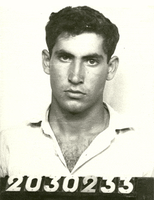 a black and white photo of a man with the number 2030235 on the bottom