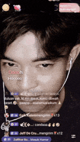 a man wearing ear buds and a microphone says oooh hoooo on the screen