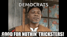 a man is sitting in a chair with the words democrats good for nothin ' tricksters written below him .