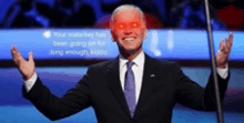a man in a suit and tie with red eyes is smiling