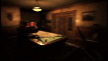 a dark room with a pool table in the middle