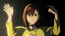 a girl in a yellow shirt has her hands up