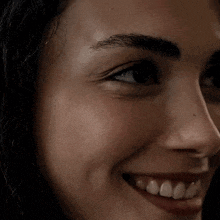 a close up of a woman 's face with a smile on it