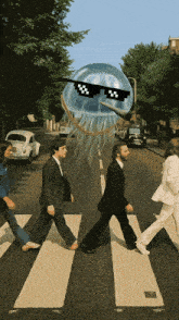 a group of people walking across a street with a jellyfish with sunglasses on
