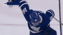 a hockey player in a blue jersey with the number 15 on the back