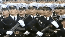 a group of men in military uniforms and hats with the letter b on their hats