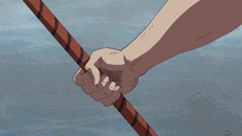 a close up of a person holding a stick in their hand